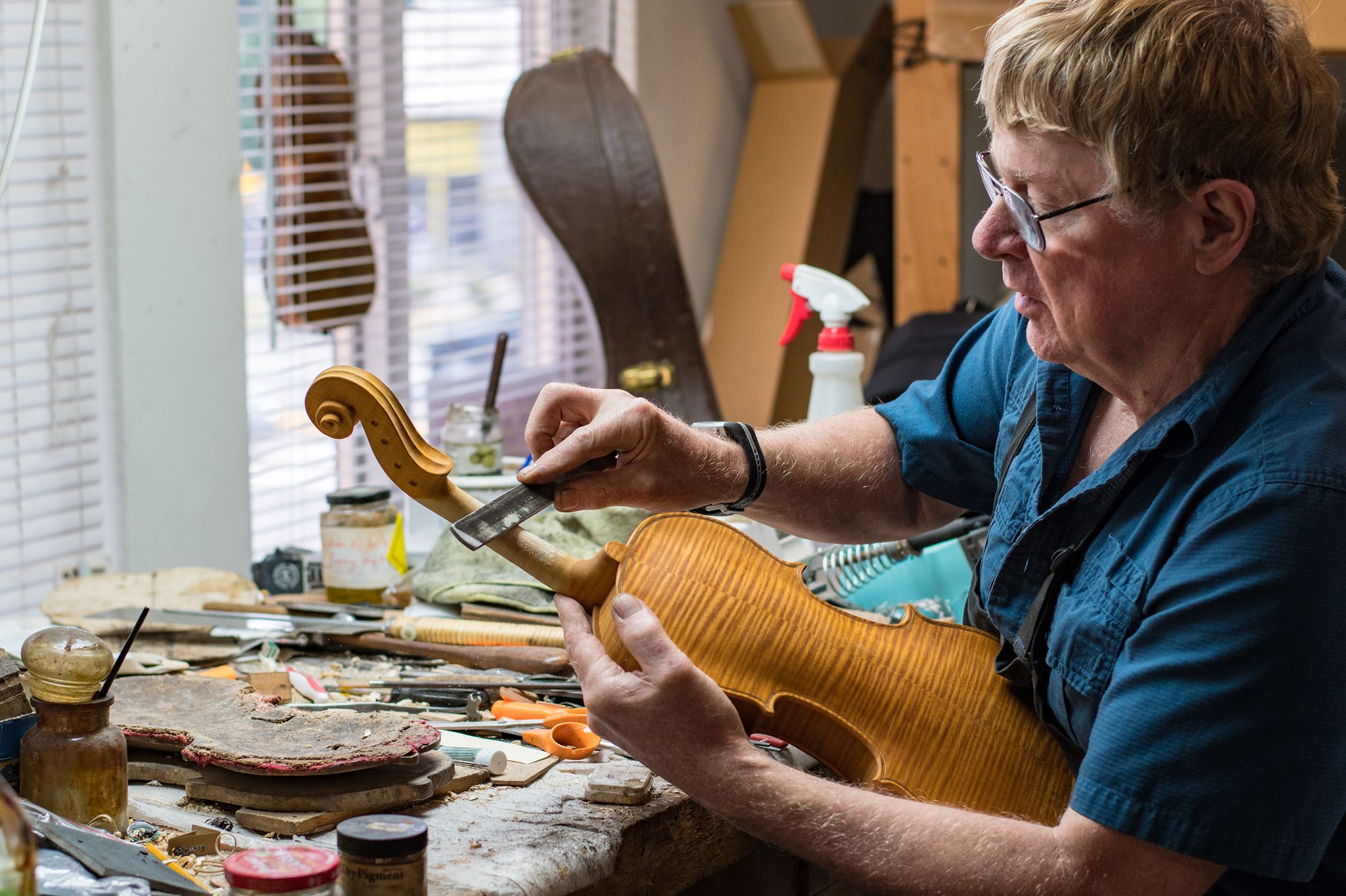 Jeff Loen at bench working on violin...